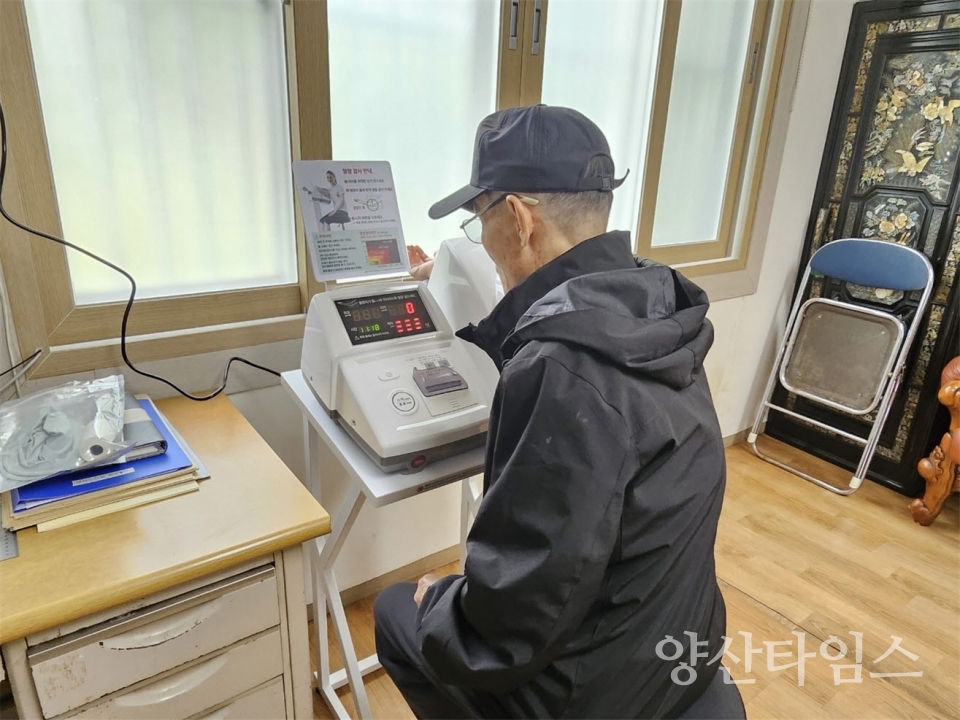 경로당을 방문한 어르신이 혈압측정기를 사용하고 있다ⓒ양산타임스